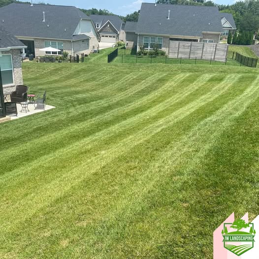 Striped residential lawn maintained by JW Landscaping