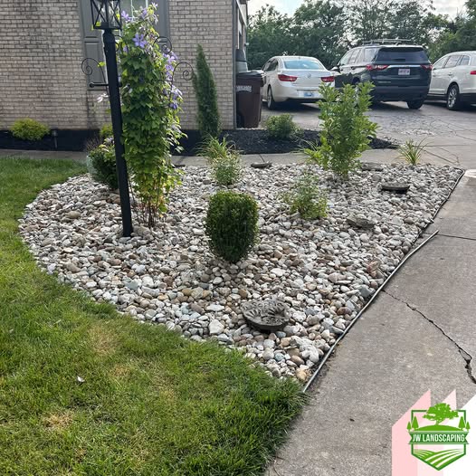 River rock landscape bed installed by JW Landscaping