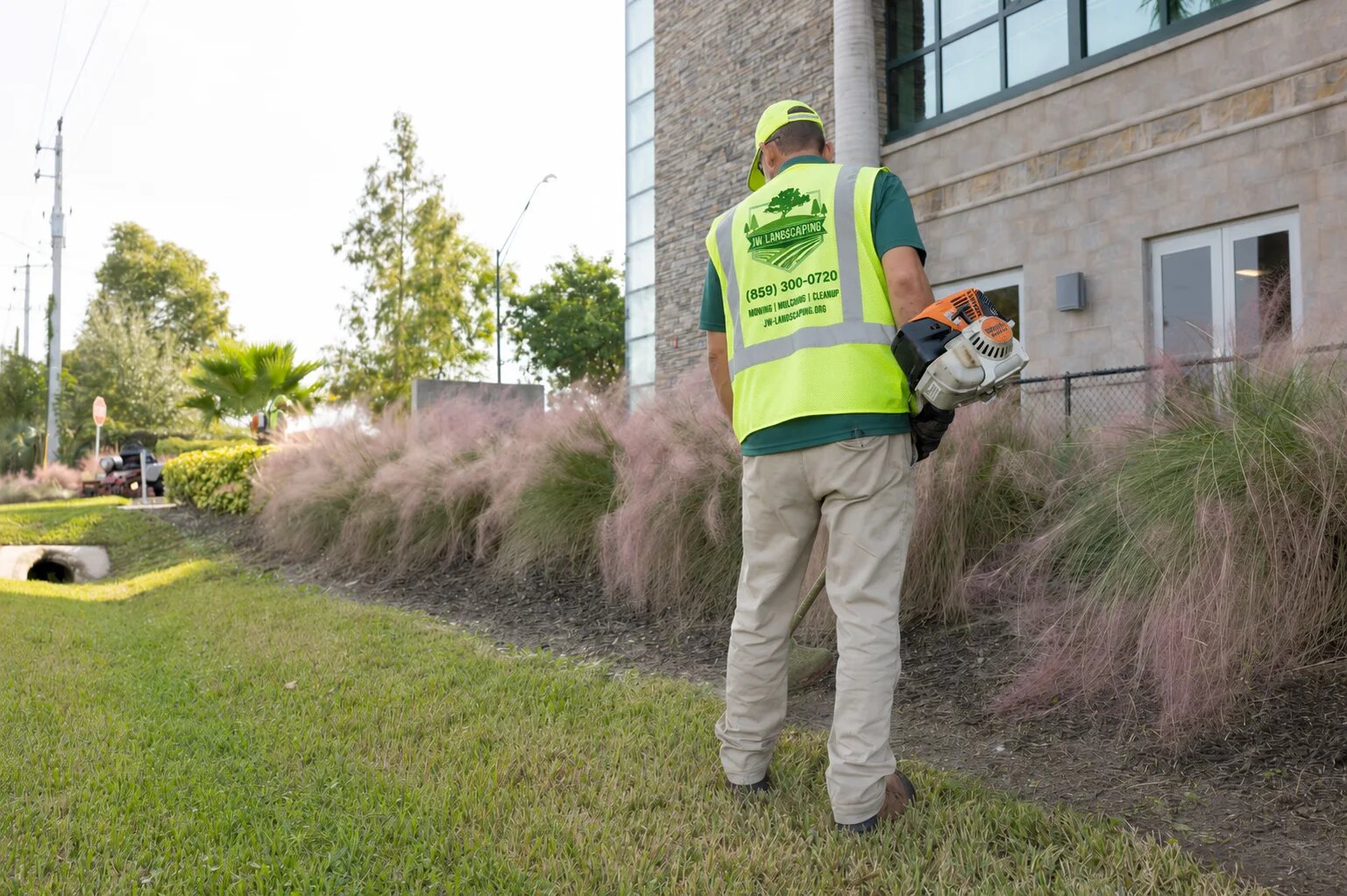 JW Landscaping crew member maintaining a commercial property in Northern Kentucky