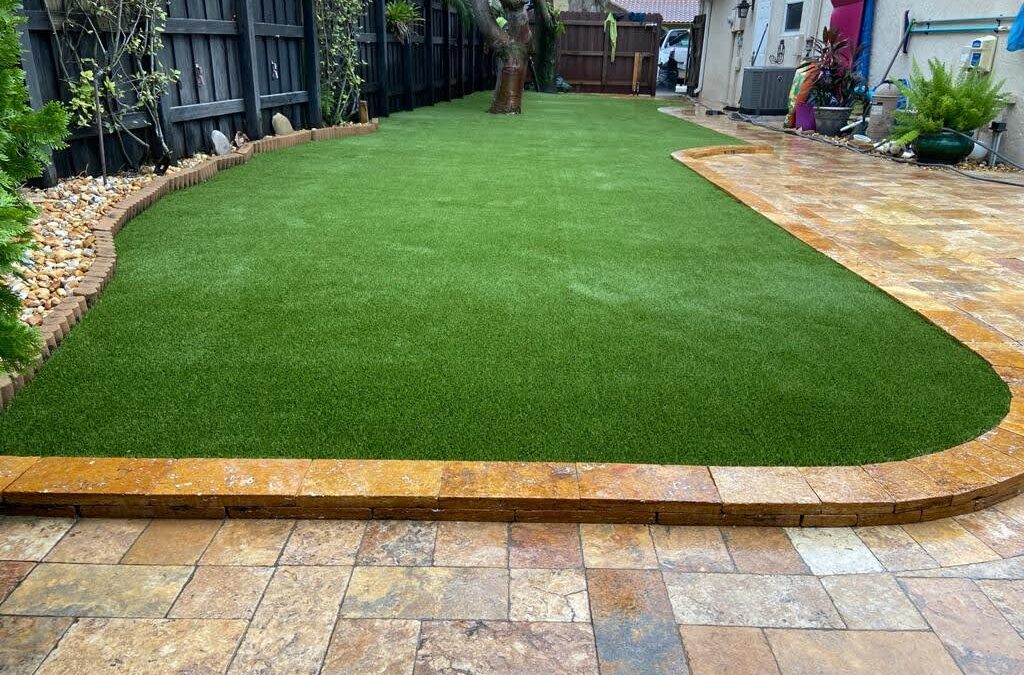 Artificial grass and paver patio installed by JW Landscaping